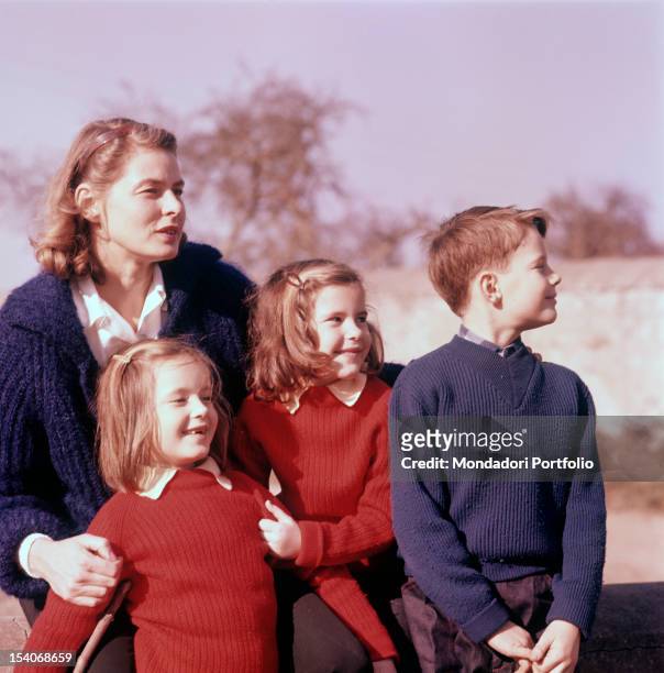 Swedish actress Ingrid Bergman hugging her children Isotta, Isabella and Robertino Rossellini. 1950s