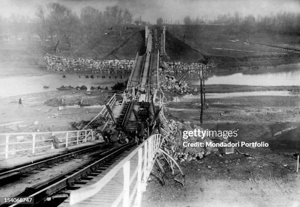 German troops advancing along the river Siret on a bridge destroyed by the Romanians during World War I. Romania, 1910s