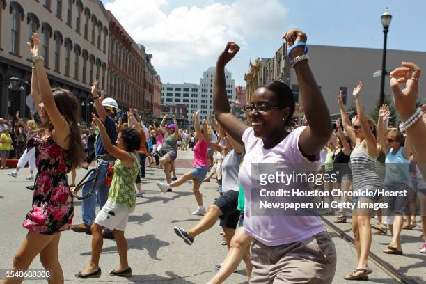 Mellodee White, front right, a League City resident who works in Galveston enjoys herself during a flash mob dance Sunday, Sept. 12 in the historic...