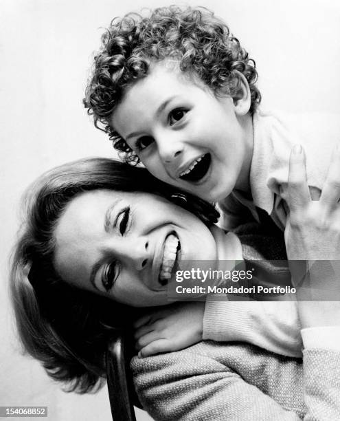 Portrait of the Italian actress and singer Ornella Vanoni smiling with her Italian son Cristiano Ardenzi. Margherita di Savoia, 1960s