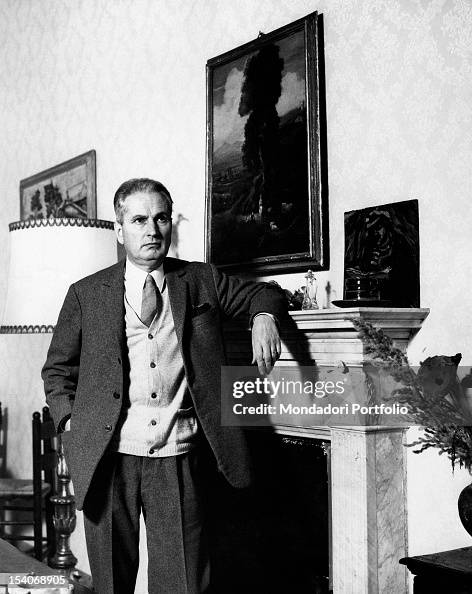 Portrait of the Italian writer Carlo Cassola leaning on the chimney