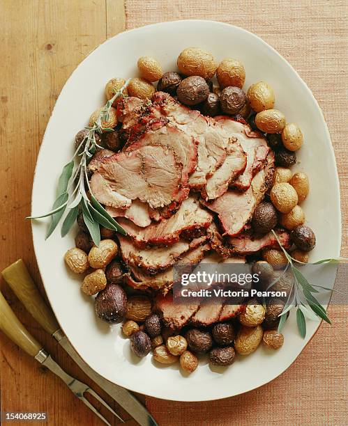 roasted pork tenderloin with potatoes. - schweinebraten stock-fotos und bilder