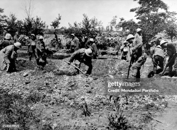 In a war cemetery, a group of Italian soldiers burying some comrades. Italy, 1910s