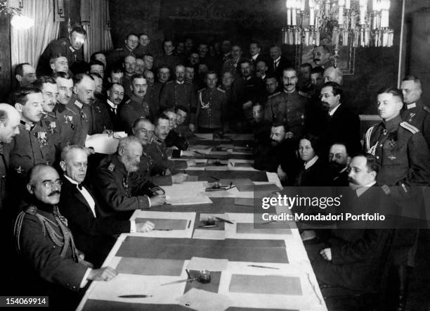 The diplomats and officers of Central Powers and Russia signing the Treaty of Brest-Litovsk ratifying the exit of Russia from World War I....