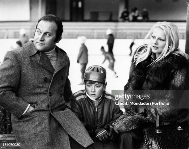 Italian actress Virna Lisi having a rest with her husband Franco Pesci and her son Corrado. Cortina d'Ampezzo, 1973