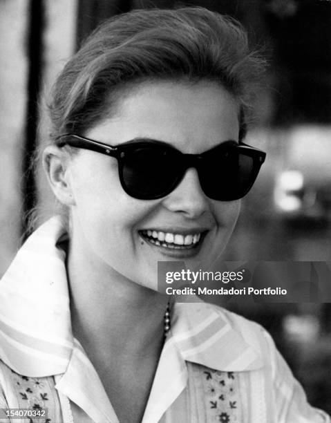 The Italian actress Virna Lisi smiling wearing a pair of sun glasses. Rome, April 1959