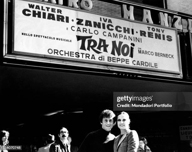 Singer Tony Renis posing with his fiancee Elettra Morini, prima ballerina at the La Scala theatre, before the Manzoni theatre, where the...