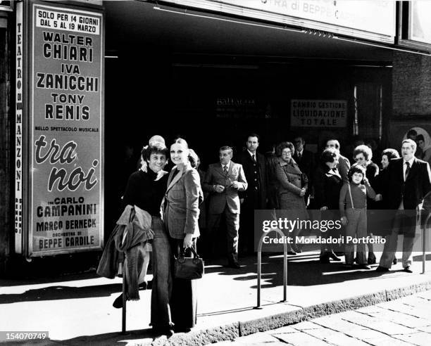 Singer Tony Renis posing with his fiancee Elettra Morini, prima ballerina at the La Scala theatre, before the Manzoni theatre, where the...