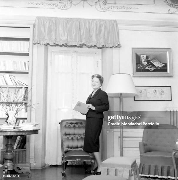 Italian writer and translator Anna Banti photographed with a book in hand in her fashionable house in Florence embellished by many artworks. Florence...