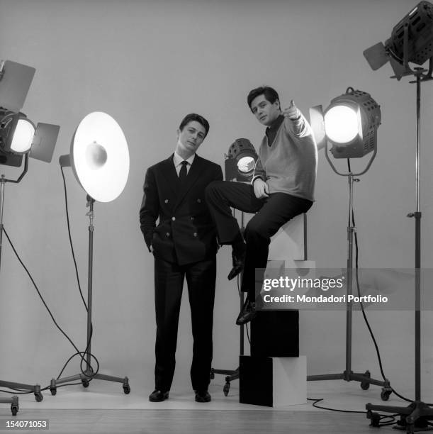 The Italian voice artist and film actor Corrado Pani is posing in a photographer's studio with the American actor Joseph Walsh: Pani is sat down on a...