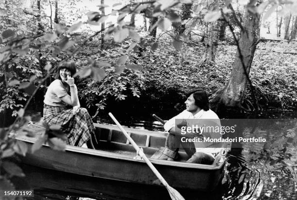 Jean Sorel with his wife Anna Maria Ferrero on a little boat along a river. Aulnay, 1970.