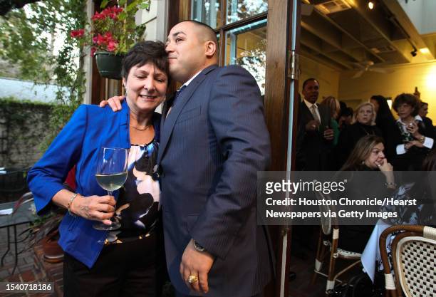 State District Judge Joan Campbell, left, gets a hug and a kiss from Julio Ibarra during a retirement part for Campbell, Thursday, Jan. 10, in the...