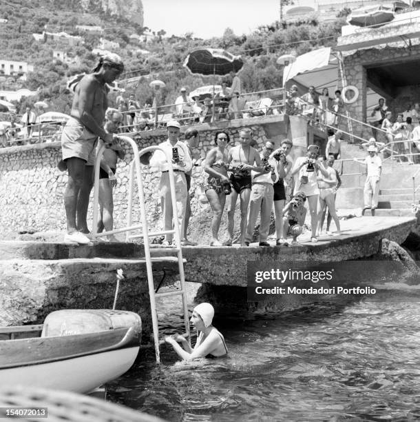 Princess Soraya of Iran climbs the ladder after a swim in the sea. Capri, the Fifties