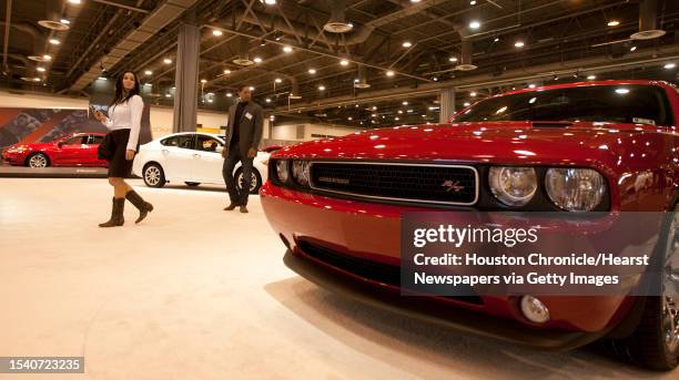 Ella Hill and Jason Hill, both of Austin, get a look at the new Dodge Challenger during the Houston Autoshow 30th Preview presented by the Houston...