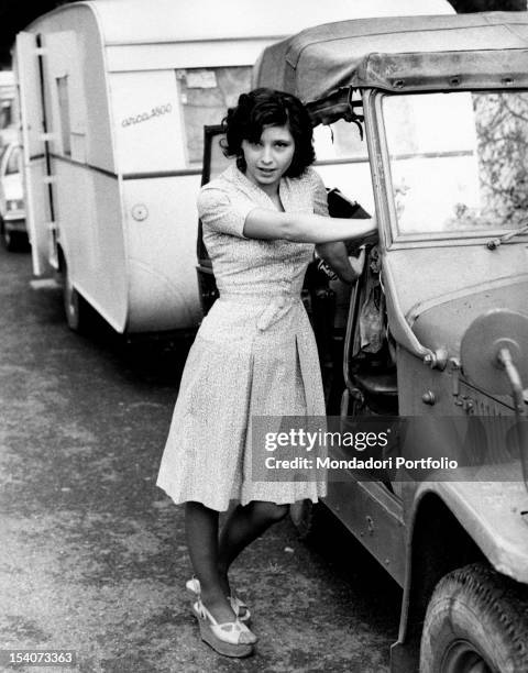 The Italian actress Lina Polito posing leaning on a jeep during a break in the film Salvo D'Acquisto. Rome, 1975