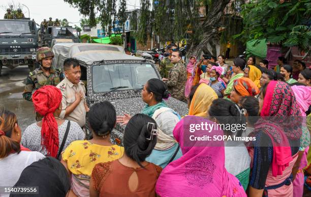 Protesters from the women's activist group Meira Paibi, block an army convoy they suspect of carrying some civilian Kuki women on their way to Imphal...