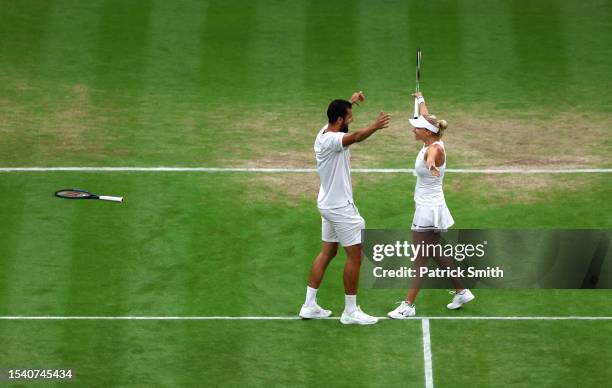 Mate Pavic of Croatia and Lyudmyla Kichenok of Ukraine celebrate following their victory during the Mixed Doubles Final against Joran Vilegen of...