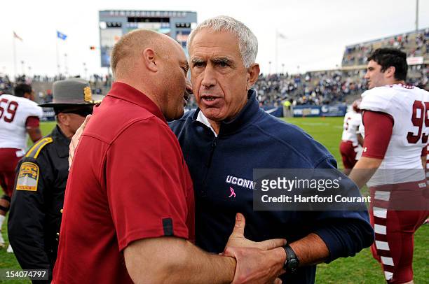 Temple Owls head coach Steve Addazio and Connecticut Huskies head coach Paul Pasqualoni meet atfter Temple defeated UConn 17-14 in overtime at...