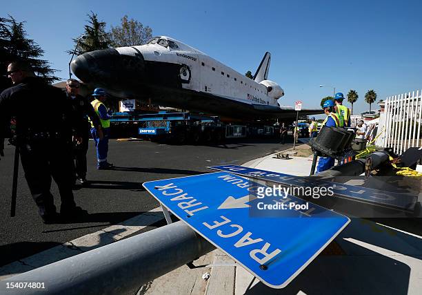 The Space Shuttle Endeavour passes a downed road sign as it is moved to the California Science Center on October 13, 2012 in Inglewood, California....