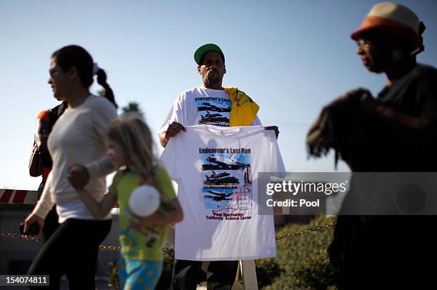 Man sells t-shirts as the Space Shuttle Endeavour is moved to the California Science Center on October 13, 2012 in Inglewood, California. The space...