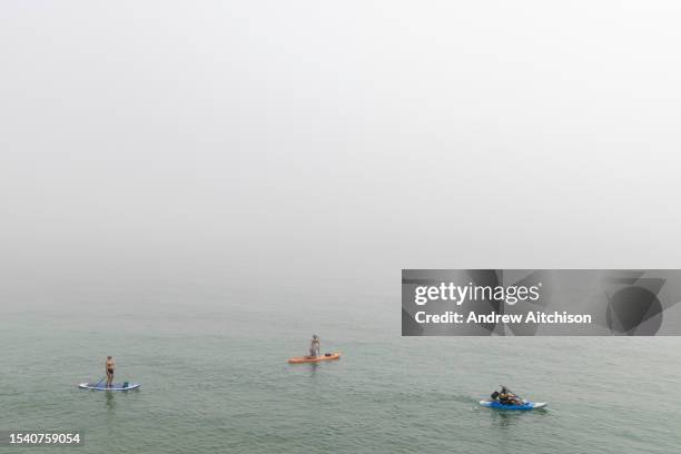 People paddle boarding and kayaking despite a sea mist near Sunny Sands beach on the 12th of June 2023 in Folkestone, Kent, England, United Kingdom....