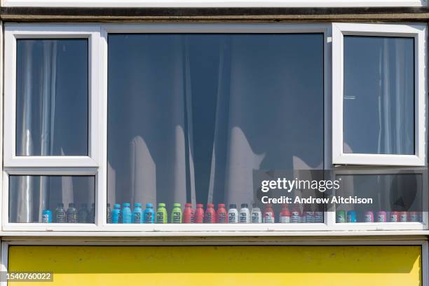 Bottles of PRIME energy sports drink lined up along the windowsill of a room in flat on the 20th of May 2023 in Folkestone, United Kingdom. Prime...