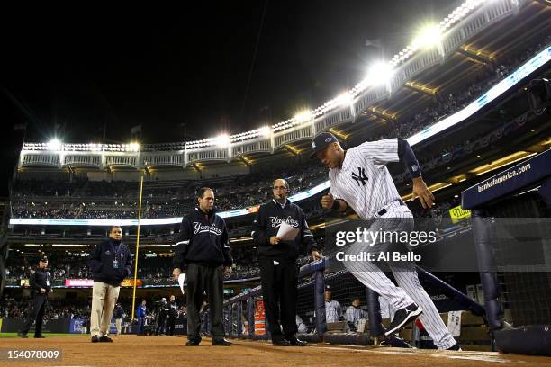 Derek Jeter of the New York Yankees runs out to the field during introductions against the Detroit Tigers during Game One of the American League...