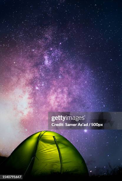 low angle view of illuminated tent against sky at night,corniglio,italy - campfire stories stock pictures, royalty-free photos & images