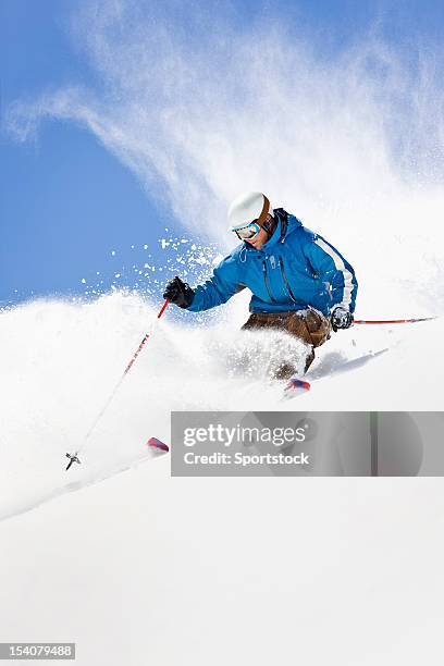 powder skiing against colorado blue sky - professional skier stock pictures, royalty-free photos & images
