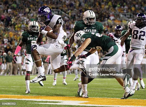 Cam White of the Texas Christian University Horned Frogs runs for a 2nd quarter touchdown against Ahmad Dixon and Sam Holl of the Baylor University...