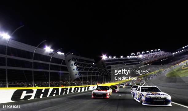 Greg Biffle, driver of the 3M/IDG Ford, and Mark Martin, driver of the Aaron's Dream Machine Toyota, lead the field during pace laps prior to the...