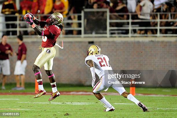 Greg Dent of the Florida State Seminoles catches a pass in front of Manuel Asprilla of the Boston College Eagles during a game at Doak Campbell...