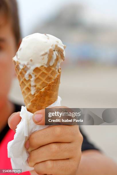 close-up of hand holding ice cream - liquid drop stock pictures, royalty-free photos & images