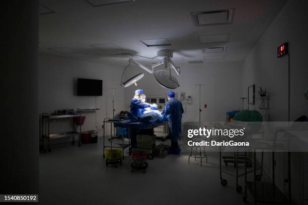 doctors in surgery in the operating room - doctora stockfoto's en -beelden