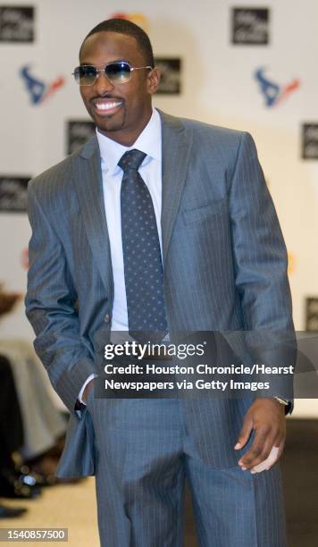 Andre Davis , shows a two button peak lapel gray and brown suit on the runway for the Saks Fifth Avenue Collection by Gruppo Vestimenta fashion show...