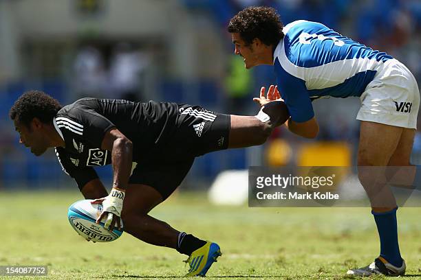 Lote Raikabula of New Zealand is tackled during the match between New Zealand and Argentina on day two of the 2012 Gold Coast Sevens at Skilled Park...