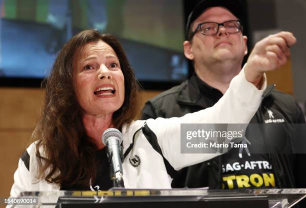 President Fran Drescher speaks as SAG-AFTRA National Executive Director Duncan Crabtree-Ireland looks on at a press conference announcing their...