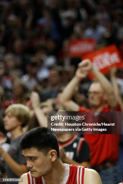 Houston Rockets center Yao Ming watched the end of his game against the Portland Trail Blazers in the fourth quarter of Game 5 of the NBA Western...