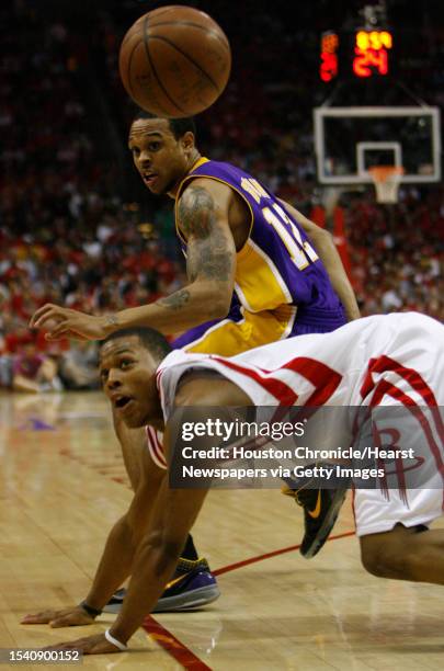 Houston Rockets guard Kyle Lowry chases a loose ball against Los Angeles Lakers guard Shannon Brown during third quarter action in game three of the...