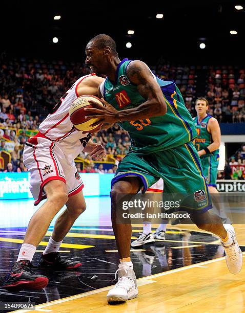 Larry Abney of the Crocodiles drives past Jeremiah Trueman of the Wildcats during the round two NBL match between the Townsville Crocodiles and the...