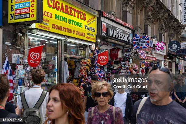 People pass souvenir shops near Piccadilly Circus on July 18, 2023 in London, England. The proliferation of American-style candy stores in Oxford...
