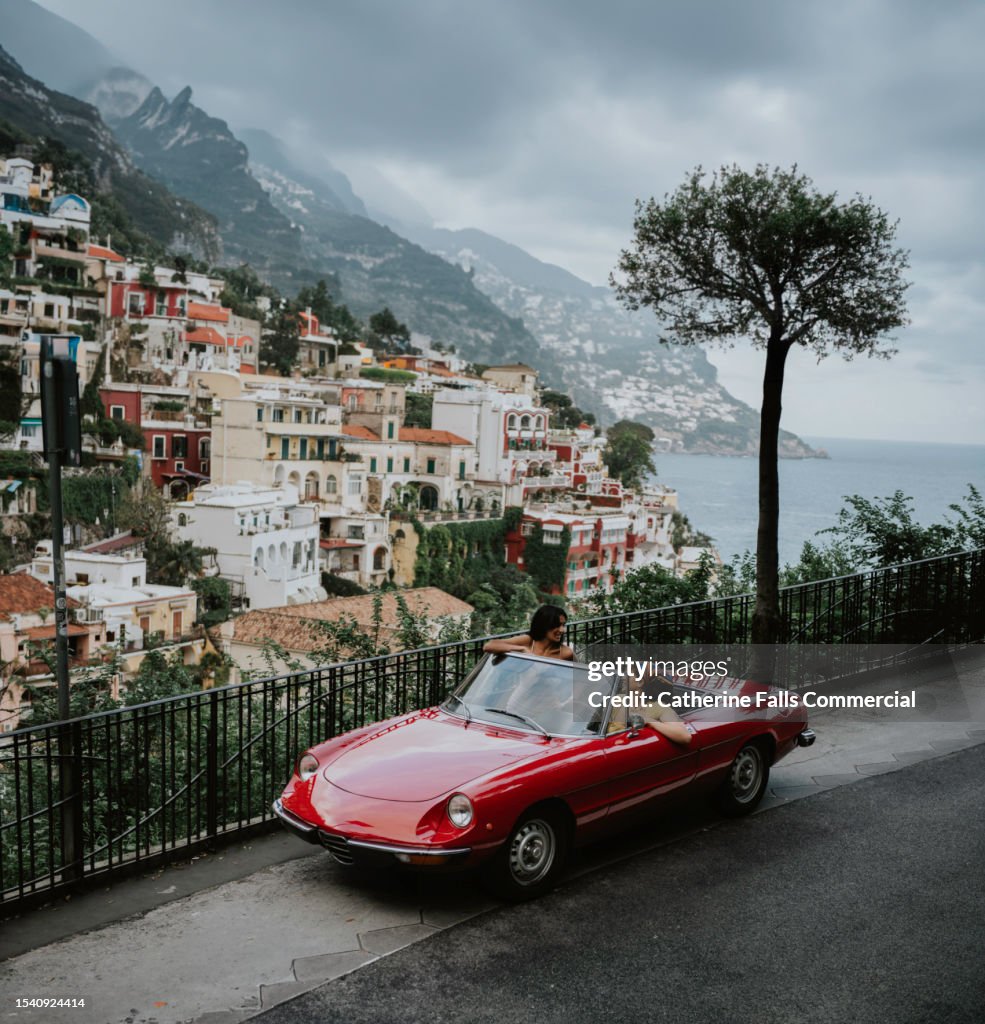 Two woman in a vintage red convertible car tour Italy