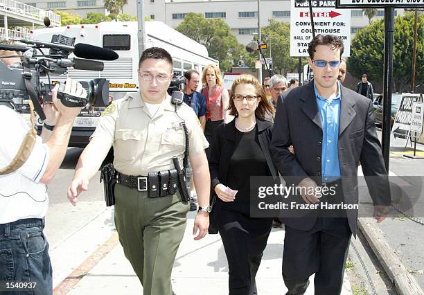 Police escort Delinah and Noah Blake, the son and daughter of actor Robert Blake, as they exit the Van Nuys courthouse after a Superior Court...