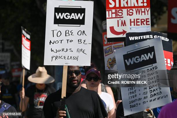 Hollywood actors, writers and their supporters walk the picket line July 18, 2023 outside Disney Studios, in Burbank, California. Tens of thousands...