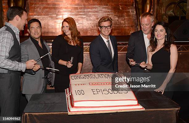 Actors Owain Yeoman, Tim Kang, Amanda Righetti, Simon Baker, Director Bruno Heller, and actress Robin Tunney participate in the cutting of cake at...
