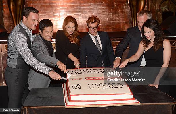 Actors Owain Yeoman, Tim Kang, Amanda Righetti, Simon Baker, Director Bruno Heller, and actress Robin Tunney participate in the cutting of cake at...