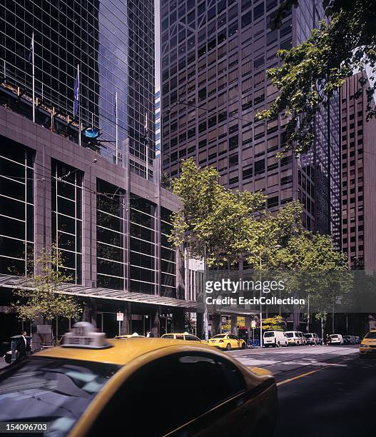 large modern office buildings and yellow cabs - australia taxi stock pictures, royalty-free photos & images