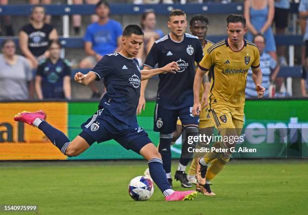 Daniel Salloi of Sporting Kansas City crosses the ball against Bryan Oviedo of Real Salt Lake in the first half on July 12, 2023 at Children's Mercy...