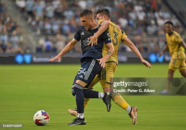 Remi Walter of Sporting Kansas City battles for the ball with Bryan Oviedo of Real Salt Lake in the first half on July 12, 2023 at Children's Mercy...