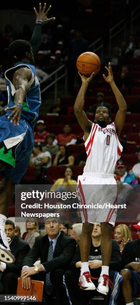 Houston Rockets guard Aaron Brooks lets a three point shot go as Minnesota Timberwolves guard Jonny Flynn jumps out to defend in the third overtime...